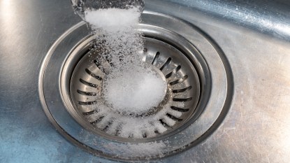 Salt being poured down sink drain