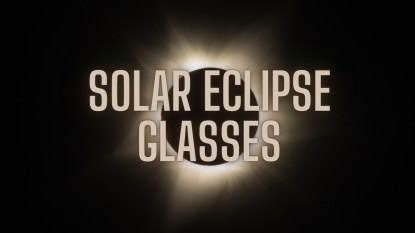 A black image of a solar eclipse with glowing text that reads 'Solar Eclipse Glasses.'