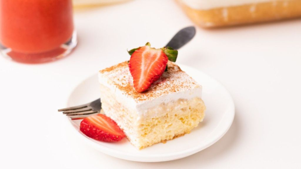 tres leches cake slice with cinnamon and strawberry