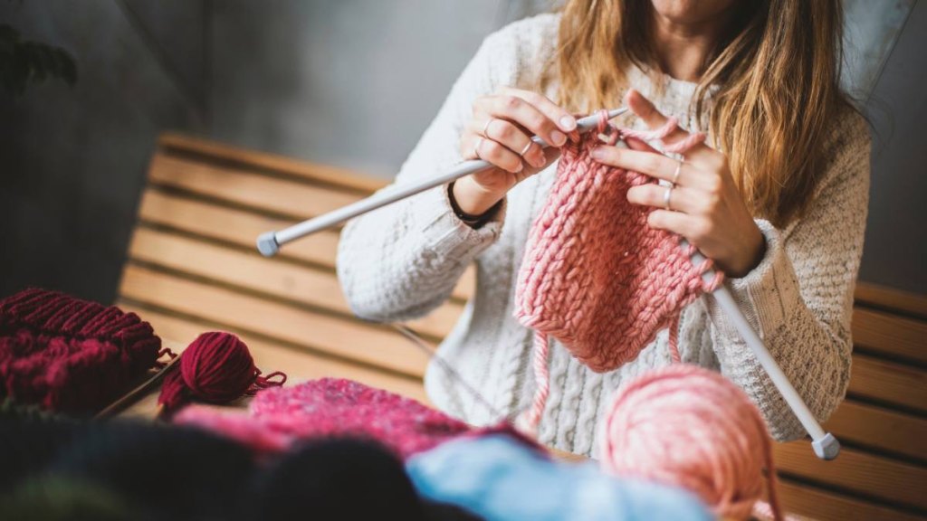 Close up on woman's hands knitting
