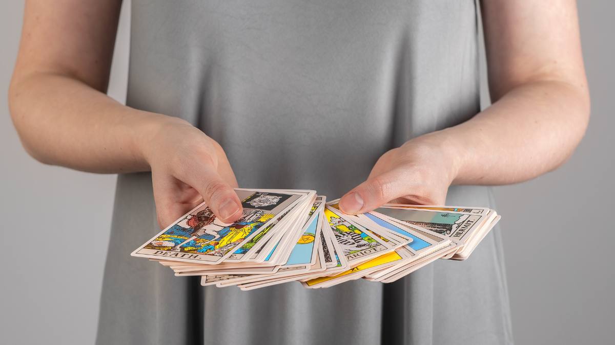 Tarot cards, many Arcanas, taro in hands of fortune teller