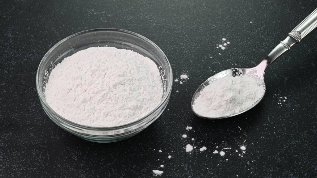 How to get rid of paint smell: Closeup view of baking powder in a bowl.