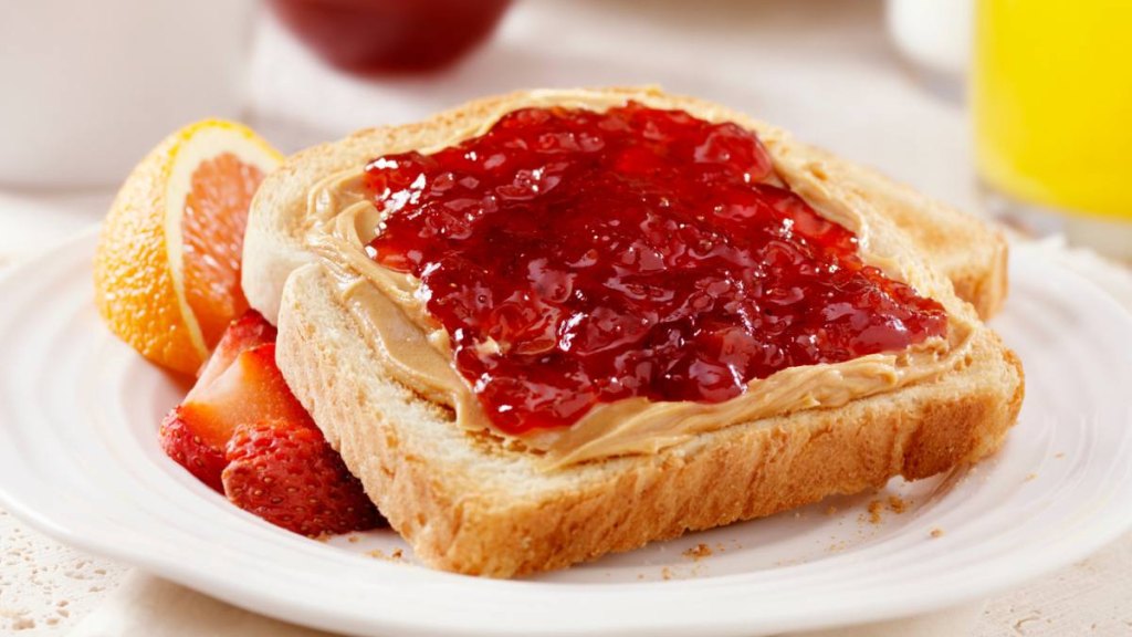 Peanut Butter and Strawberry Jam on Toast with Orange Juice and Milk