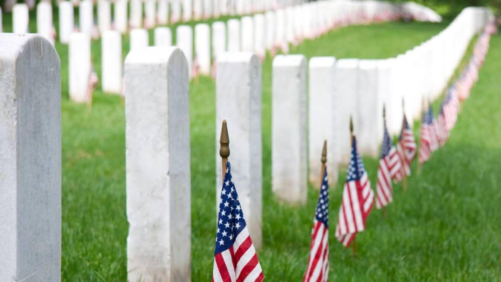 Memorial Day quotes and flags at gravestones