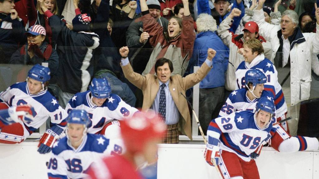 Man cheering at hockey game; patriotic movies