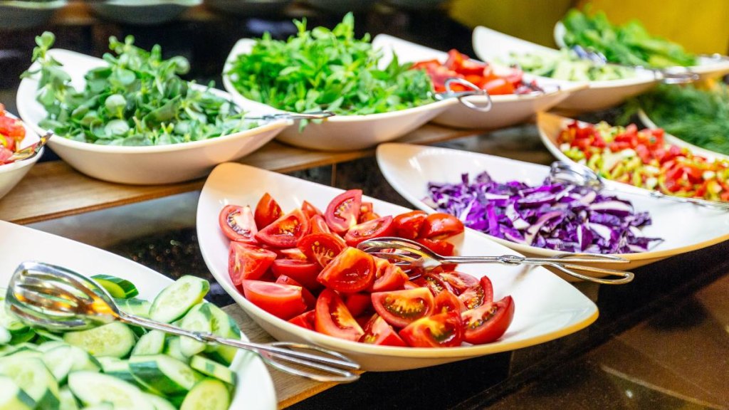 Salad bar with fresh vegetables in hotel buffet