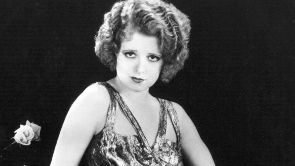 Silent screen siren Clara Bow (1905 - 1965) popularly known as the 'It' girl, wears a silver lame dress for the Paramount film 'No Limit', directed by Frank Tuttle.