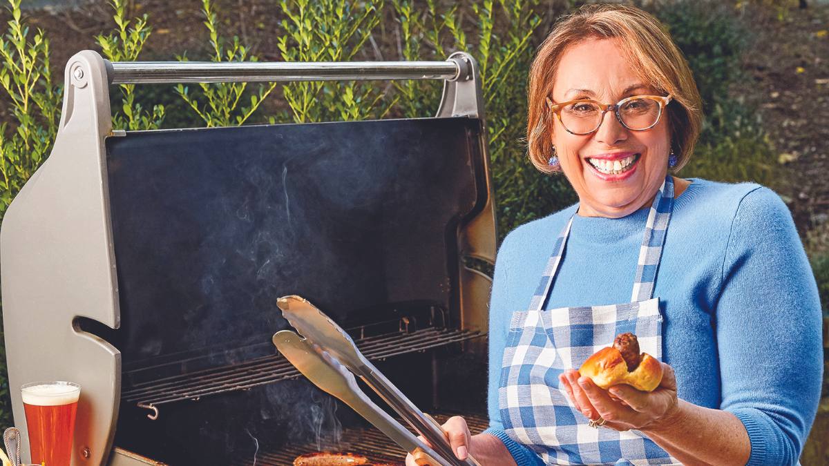 Babs with a grill, hot dog, and a beer.