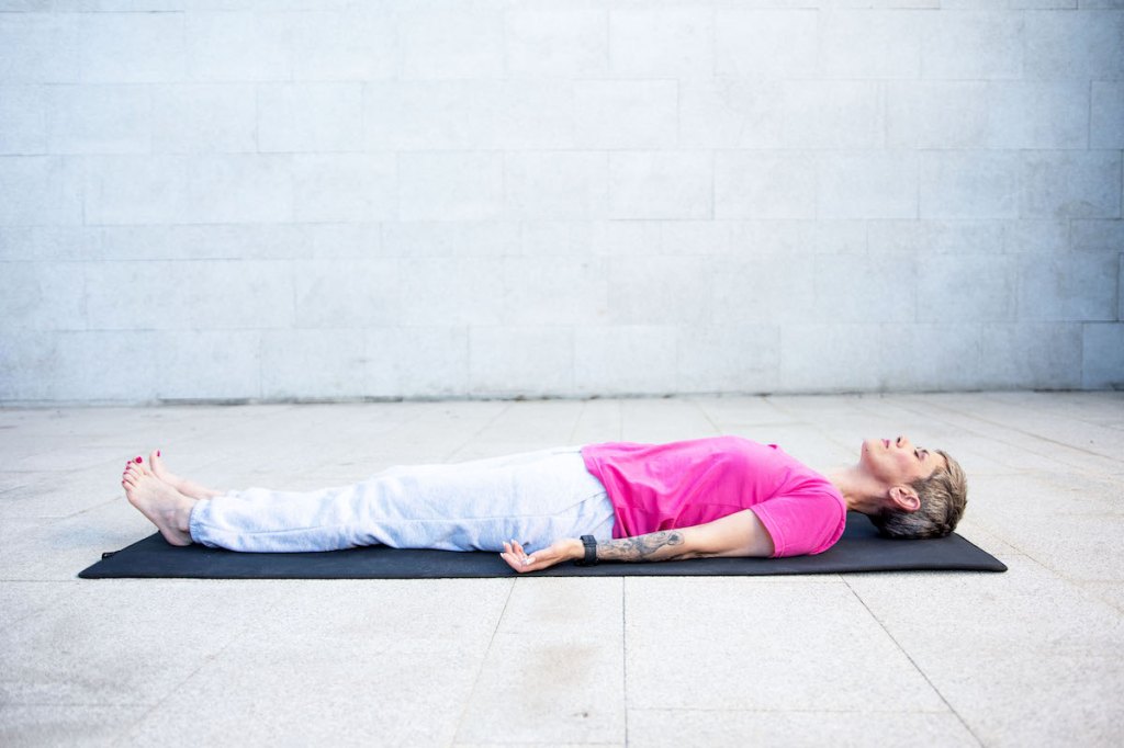 Woman laying on yoga mat