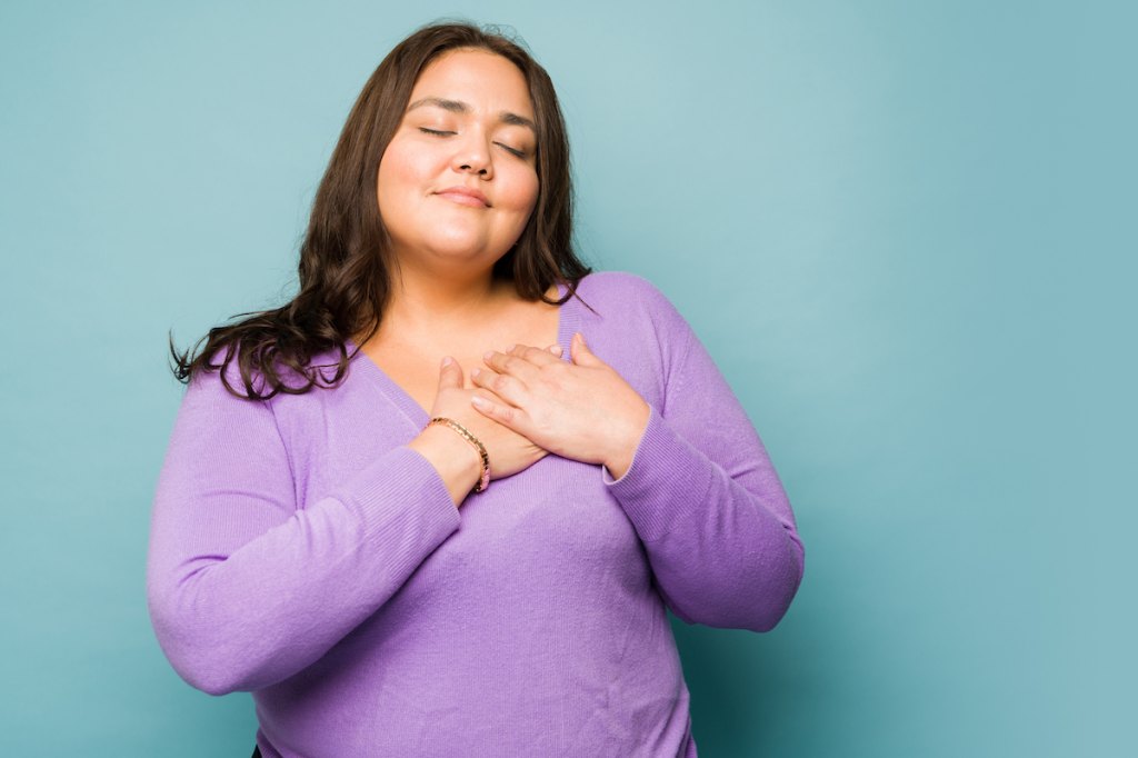 Woman with her hand on her heart