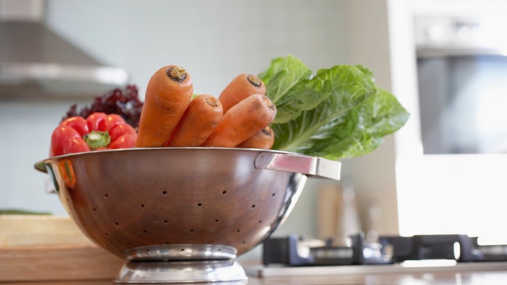 A colander full of assorted vegetables