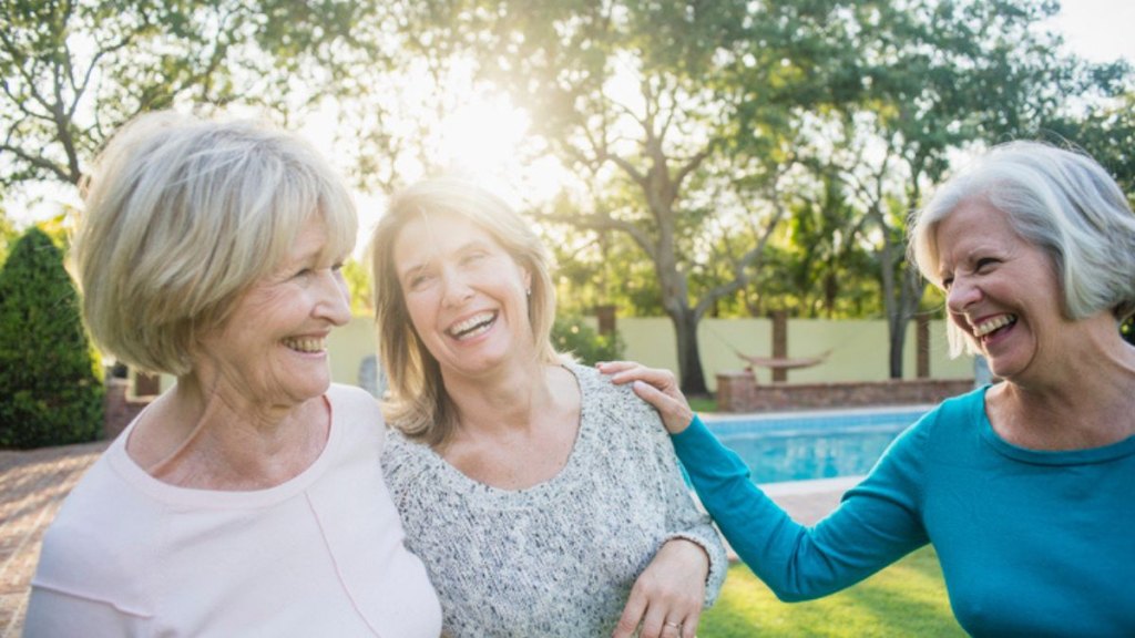 mature friend group laughing outside