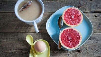 sliced grapefruit halves with hard boiled egg and tea