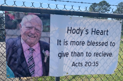 Hody's Heart banner hangs on a fence in the town