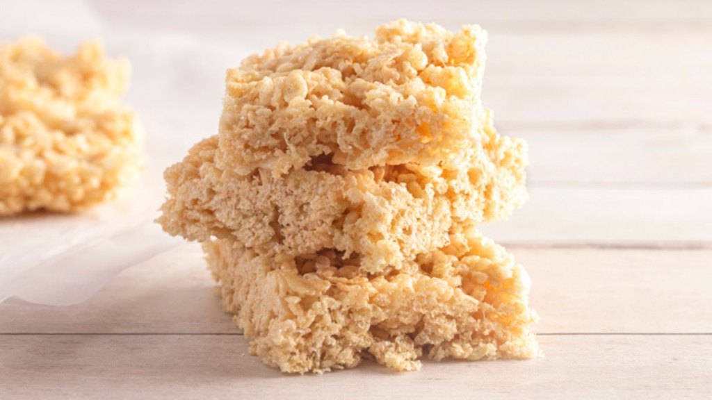 three microwave rice cereal treats stacked against white background