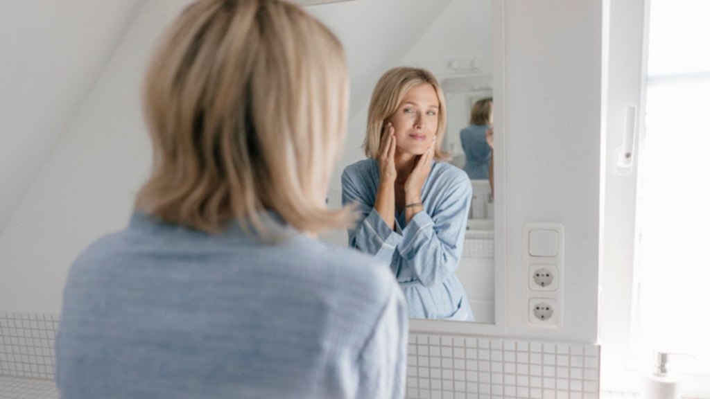 Mature woman looking at clear skin after eating oats