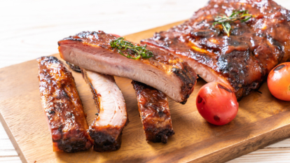 oven-baked baby back ribs sliced on cutting board