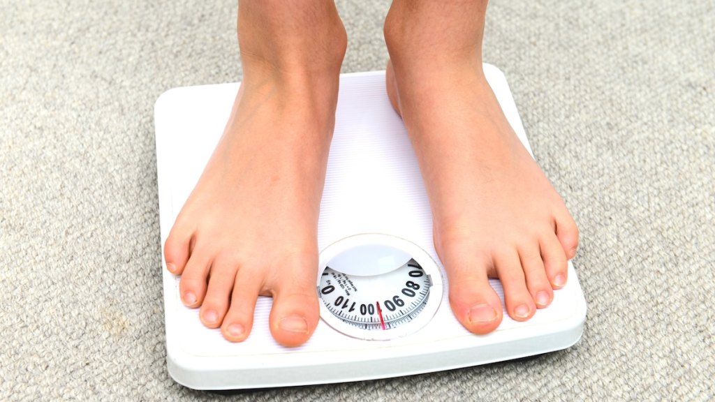 Person stepping on a scale.