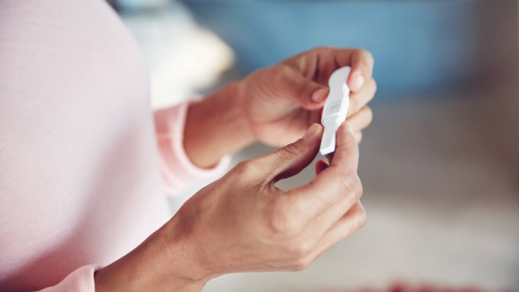 Cropped shot of a woman waiting for the results of a pregnancy test