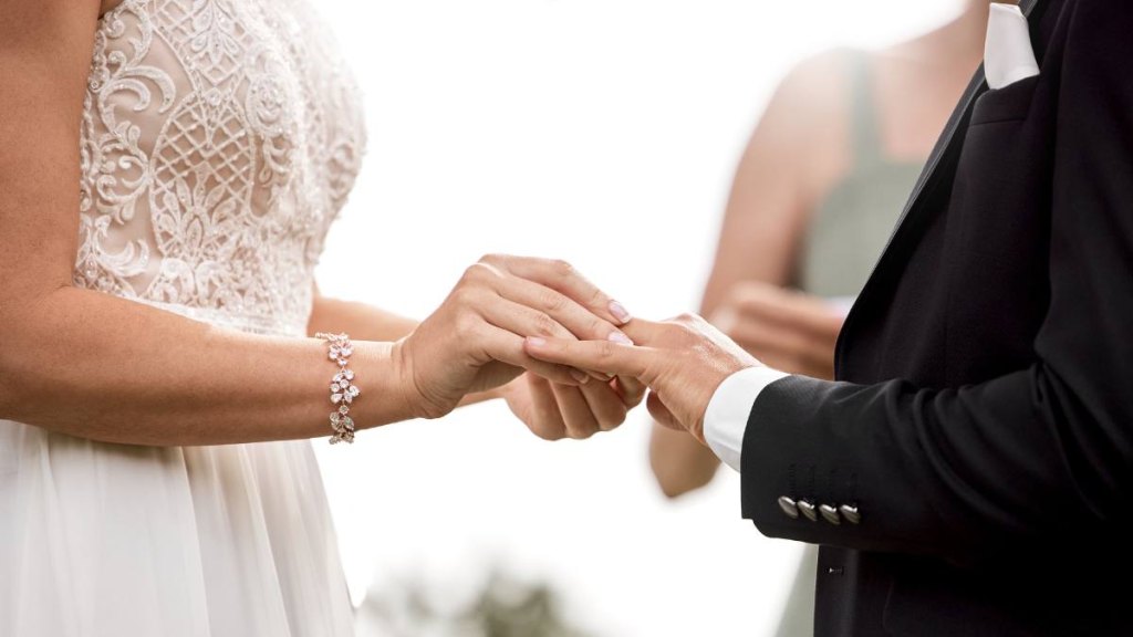 Wedding ring, couple commitment and hands during love event, start of bride and groom marriage and celebration together at reception. Man and woman in happy and trust union at ceremony in nature (wives tales summer solstice )