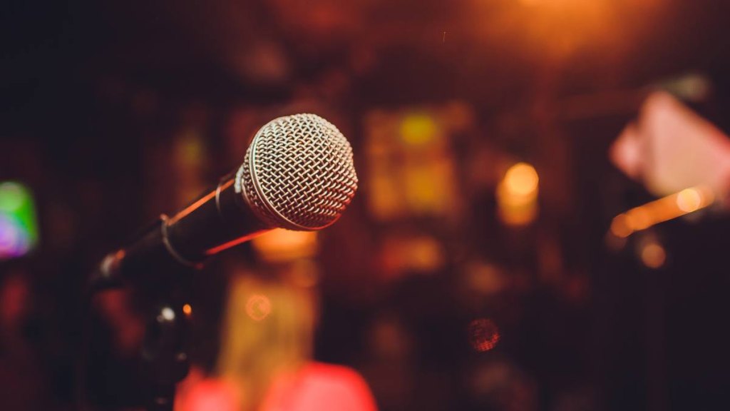 Microphone on stage against a background of auditorium