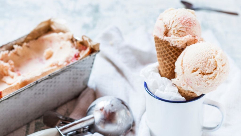 homemade gelato in loaf pan with scooped cones on the side