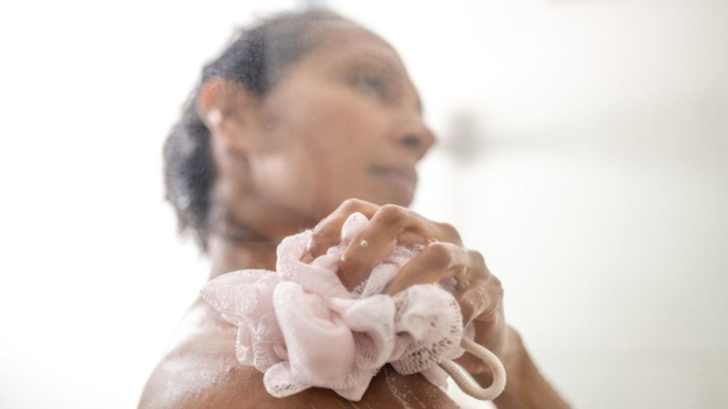 mature woman using unscented body soap in shower to avoid recurrent yeast infections during menopause
