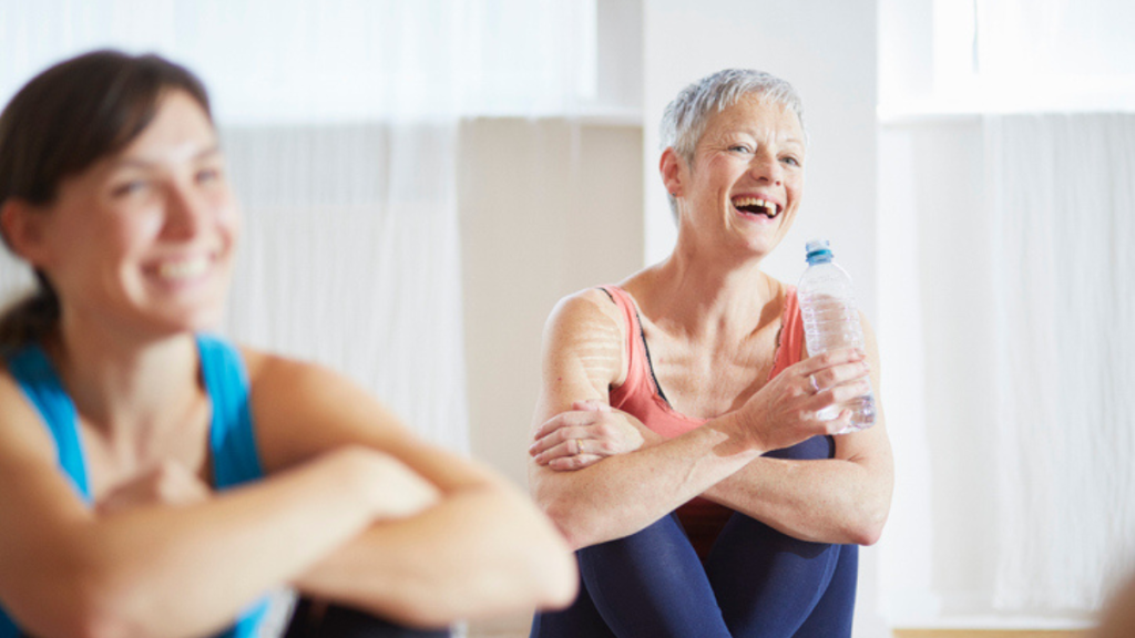 mature woman laughing in a laughter yoga class