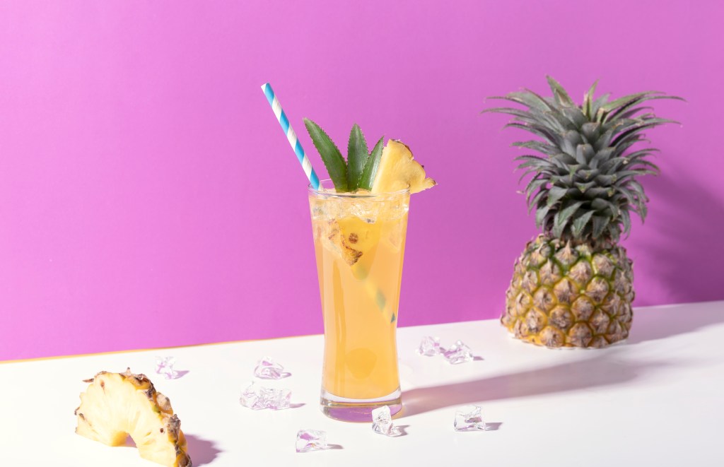 Glass of punch with pineapple garnish 