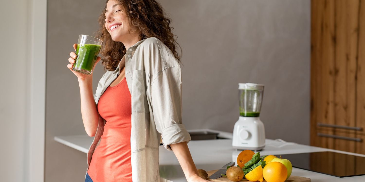 A woman drinking greens powder.