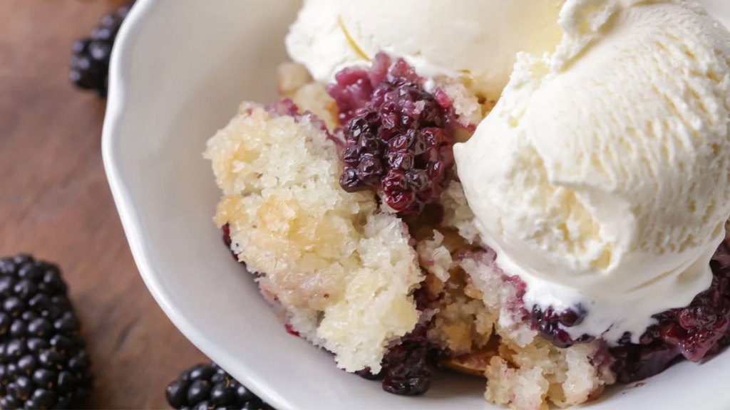 Blackberry cobbler in a bowl with ice cream