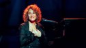 woman sitting at piano; carole king songs