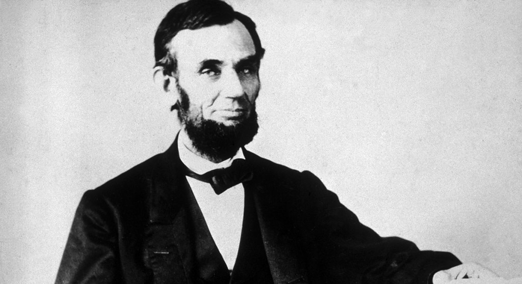 The 16th American president, Abraham Lincoln (1809 - 1865), sitting and leafing through documents, Washington, D.C.