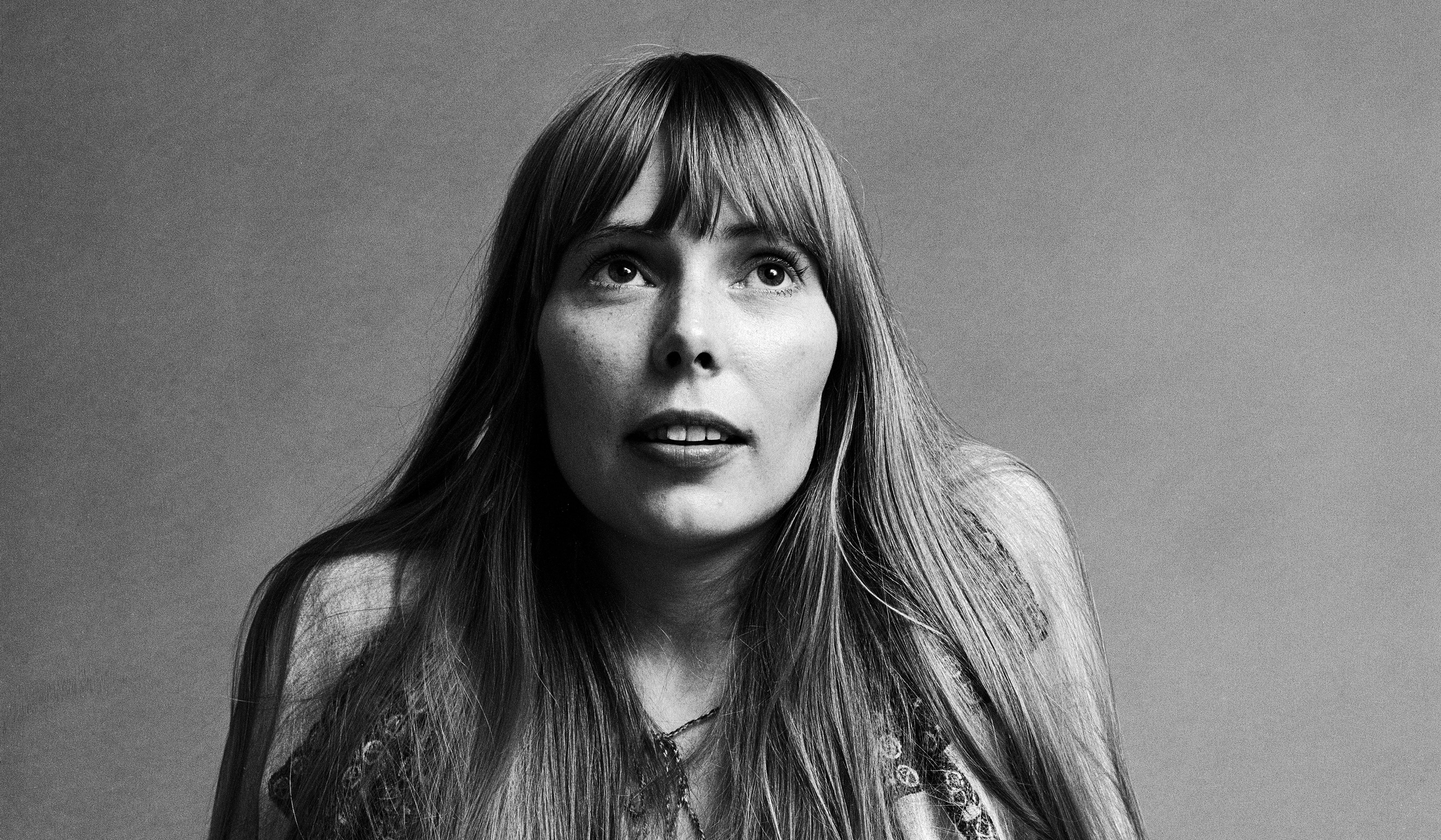 woman looking up smiling; joni mitchell songs