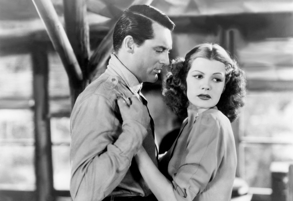 man and woman holding each other; rita hayworth young
