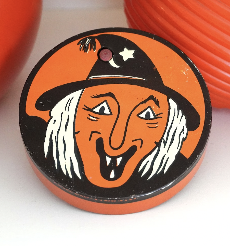 Vintage Halloween noisemaker with illustration of witch