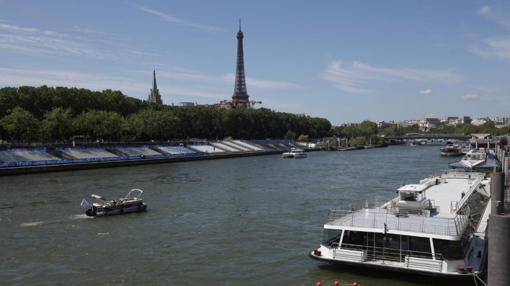 are they swimming in the seine: Boats are navigated on the Seine river with Eiffel Tower in background, after the first triathlon training session was cancelled during the Paris 2024 Olympic Games in Paris, on July 28, 2024, due to the pollution of the Seine river. The improved weather failed to prevent the first triathlon training session in the River Seine from being cancelled on July 28, 2024. Following a meeting "on the water quality" and tests, "a joint decision was taken to cancel the swimming part of the triathlon orientation," a Paris 2024 and World Triathlon statement said.
