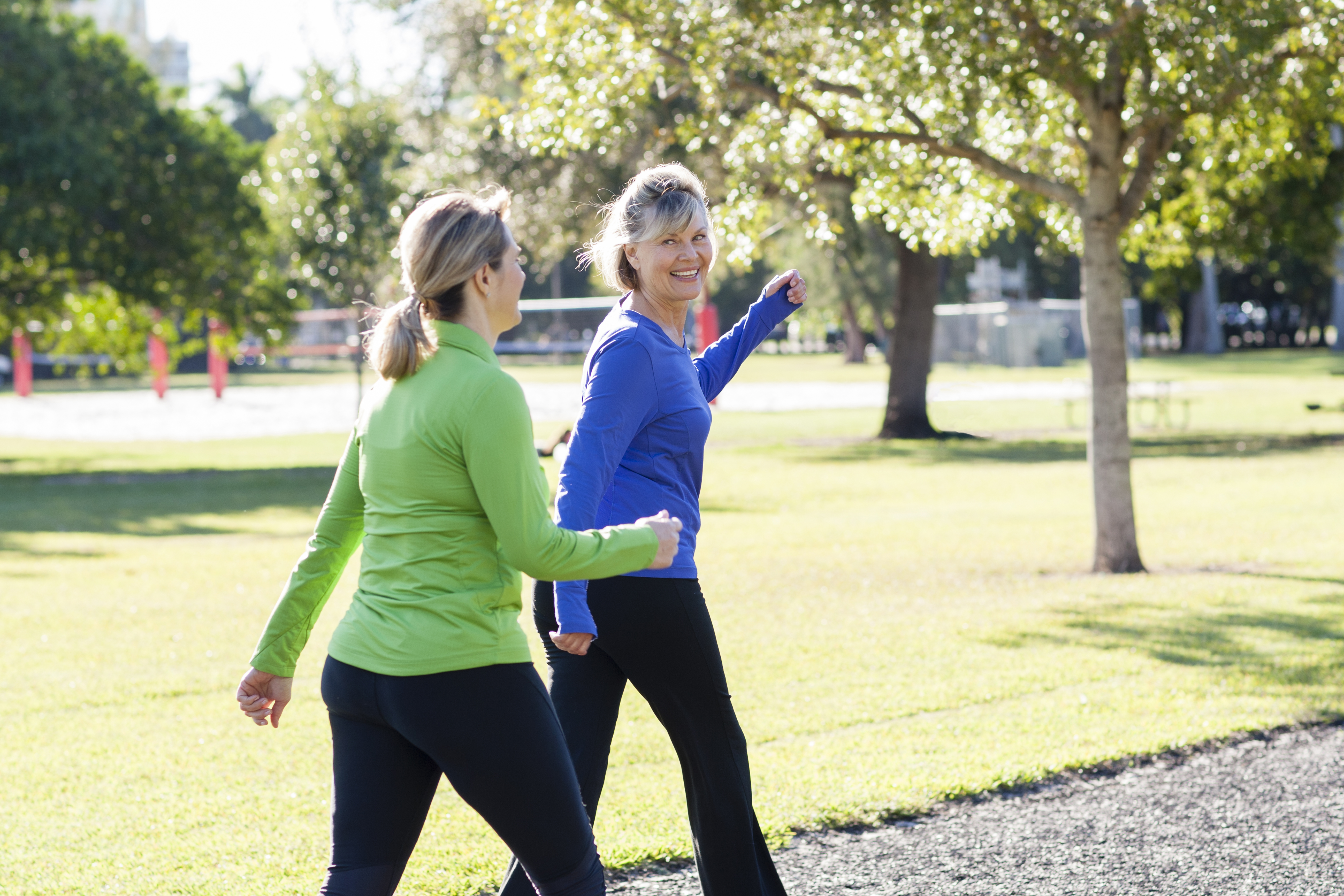 Two women walking in park