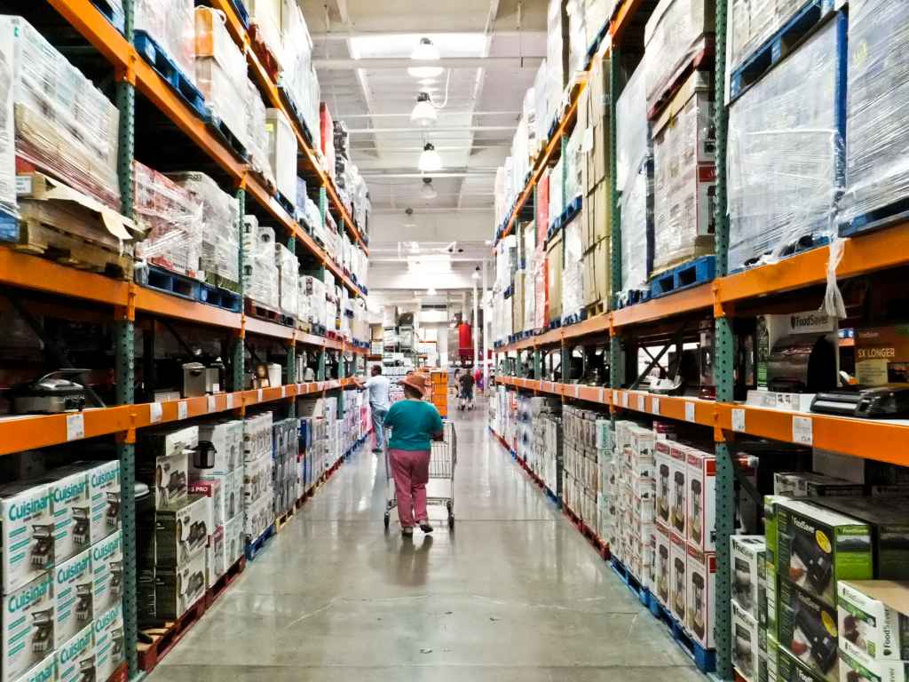 Woman walking down shopping aisle at Costco
