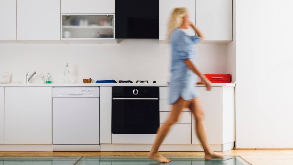 Woman walking around kitchen