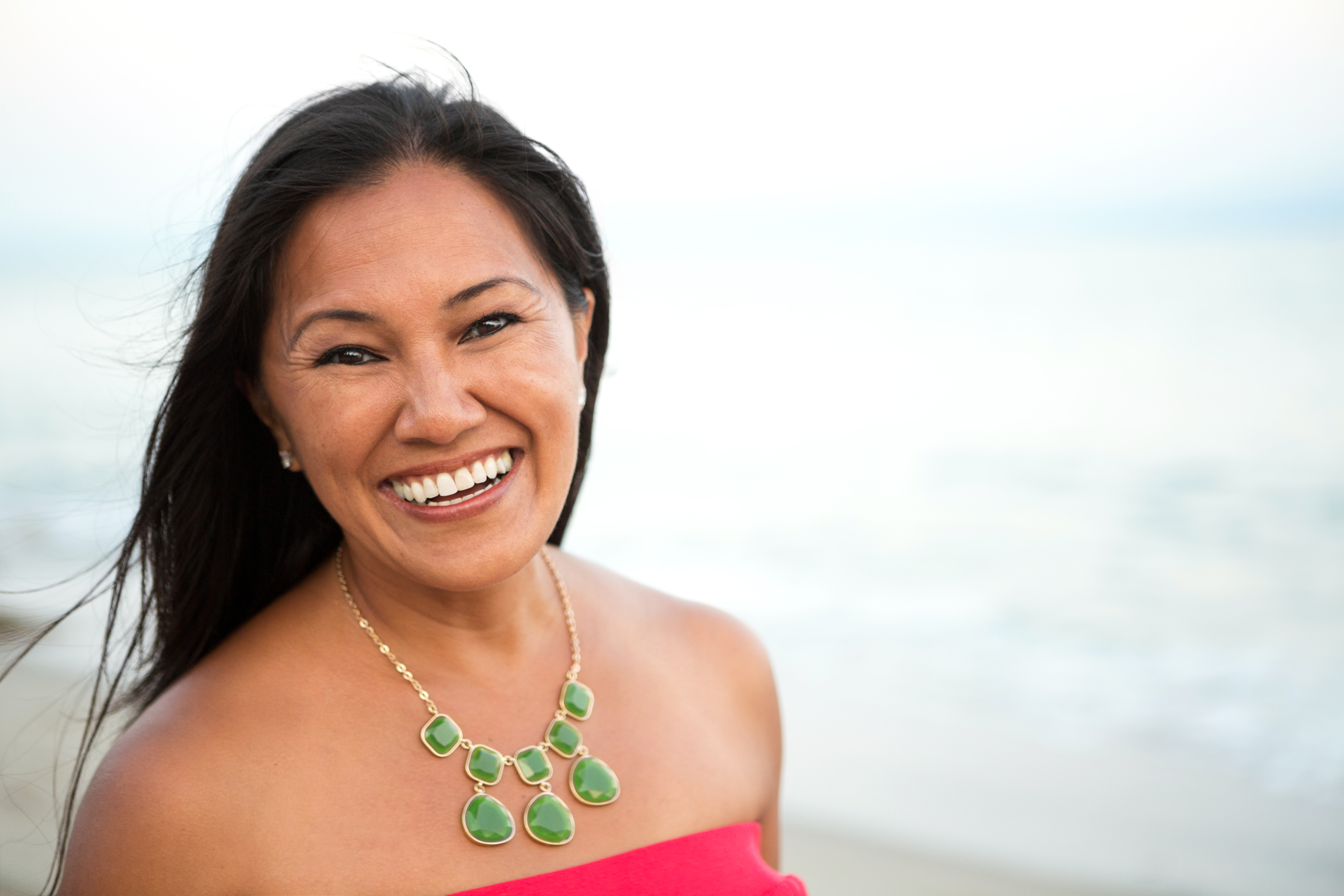 Woman at the beach with gorgeous hair after doing a post-beach hair care routine