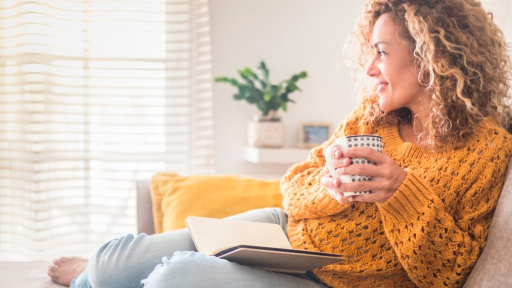 Woman relaxing on couch reading a book