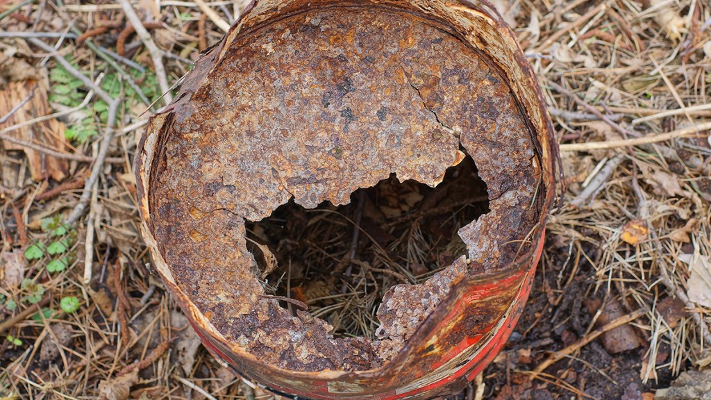 Badly corroded trash can