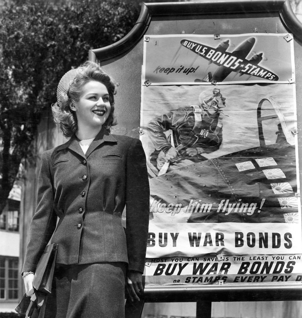 Women in front of a War Bonds sign in 1943