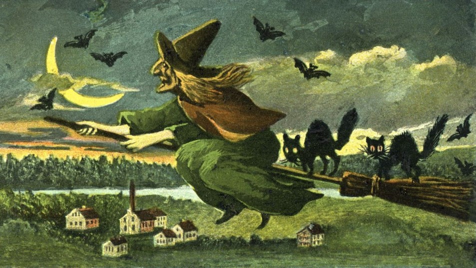 Vintage Halloween postcard showing a witch riding on her broom