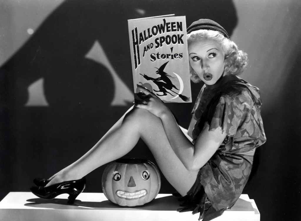 Betty Grable posing with Halloween memorabilia in 1938