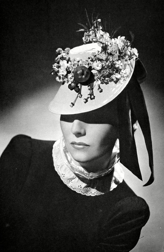 Woman in a hat decorated with fruit and flowers (1940)