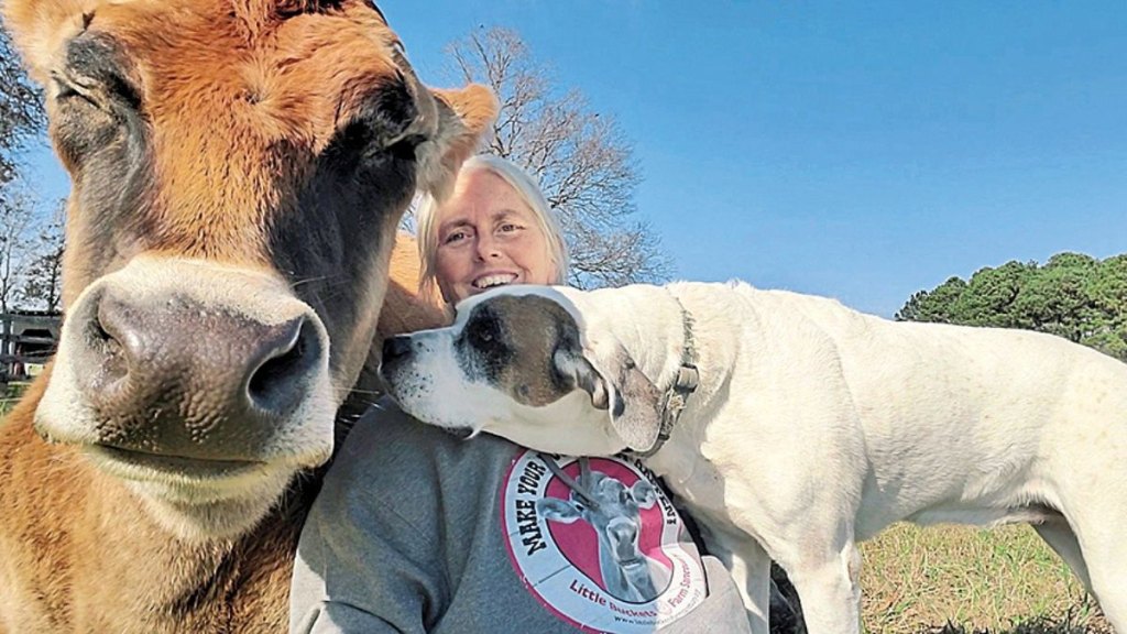 Woman with cow and dog