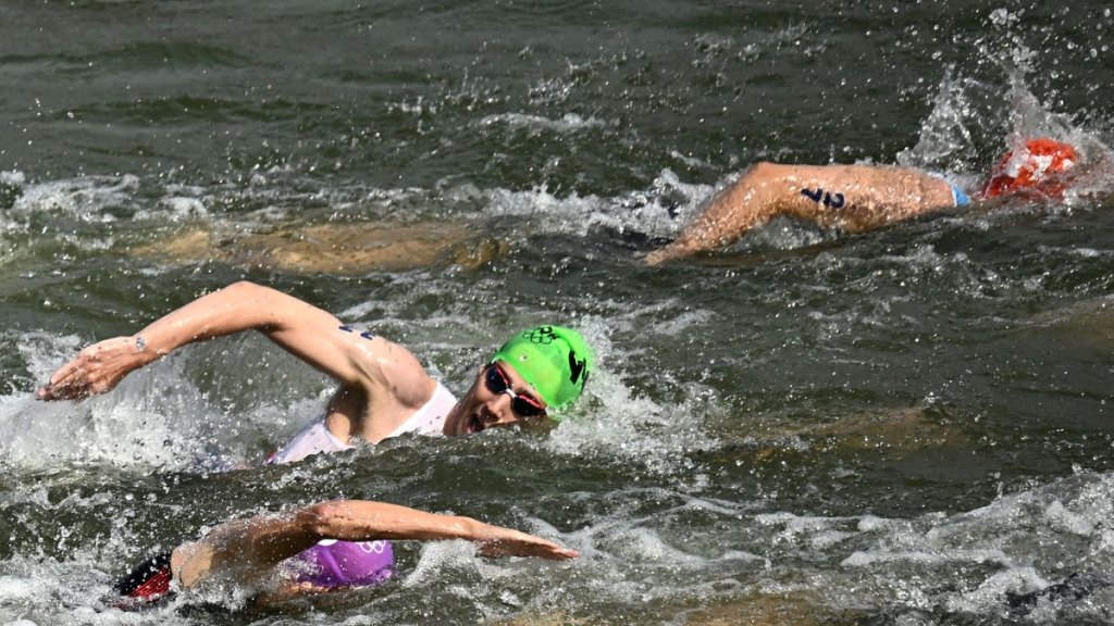 Athletes compete in the swimming stage in the Seine river during the men's individual triathlon at the Paris 2024 Olympic Games in central Paris on July 31, 2024