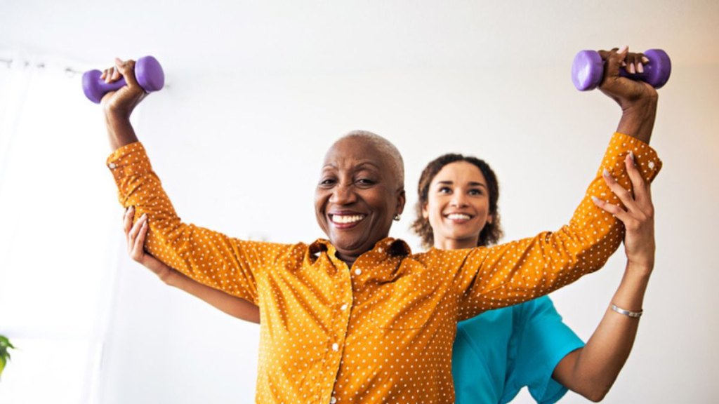 mature woman in physical therapy to reduce symptoms of stiff person syndrome